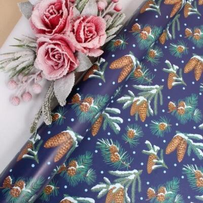 Бумага упаковочная новогодняя глянцевая 70*100 см Еловые шишки на синем 10 л/уп 568031