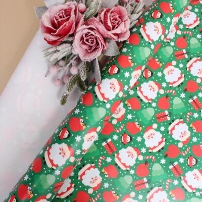 Бумага упаковочная новогодняя глянцевая 70*100 см Краснощекий Дед Мороз на зеленом 10 л/уп 568024