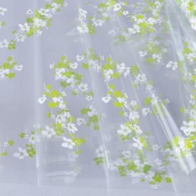 Пленка упаковочная прозрачная с рисунком для цветов и подарков в рулоне Анютины глазки 70 см Бело-салатовый